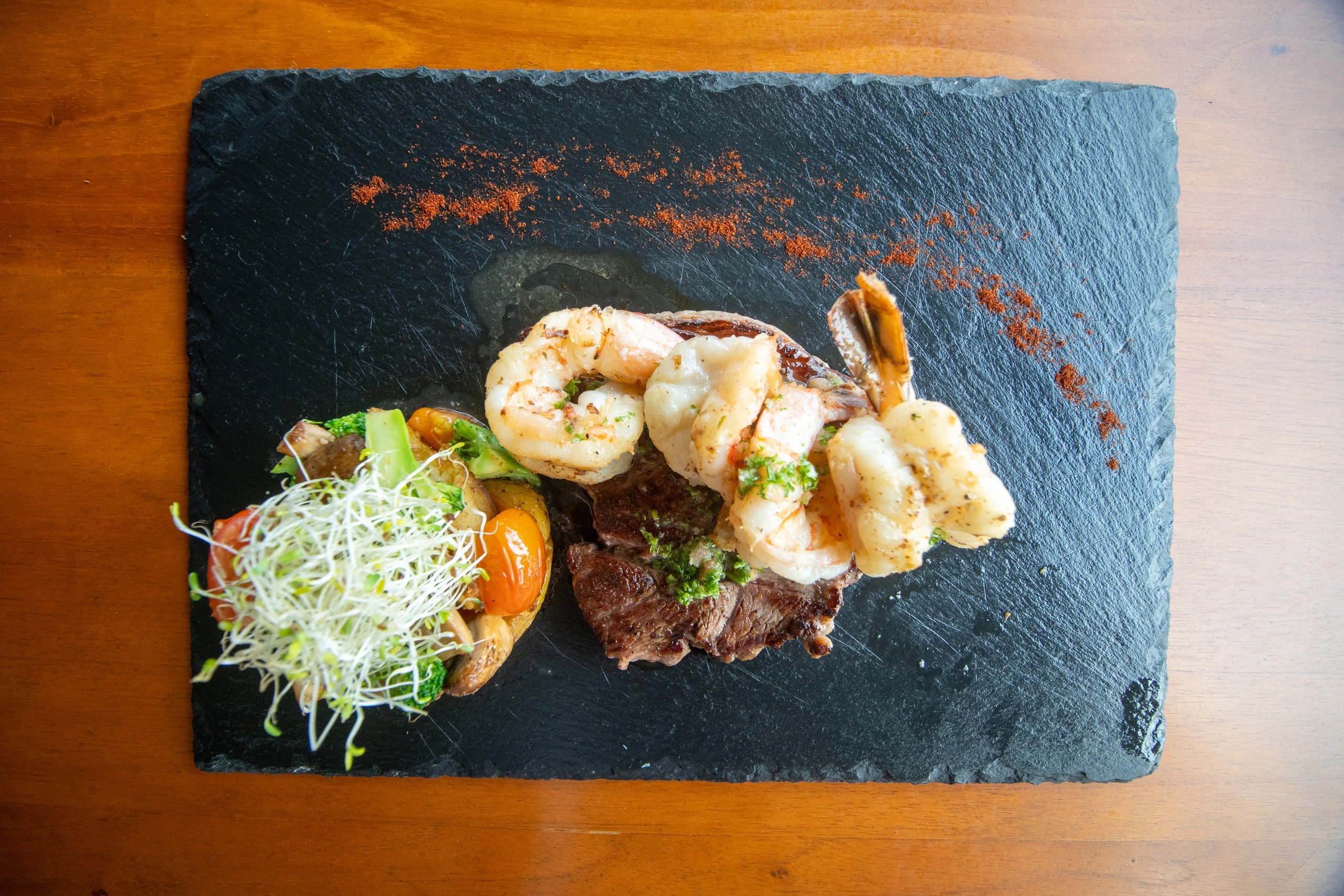 A plated meal served on the wooden terrace at Taste of Agape